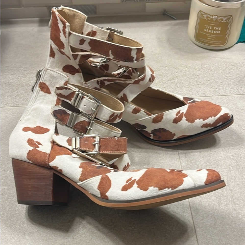 Cow print buckle heeled boots
